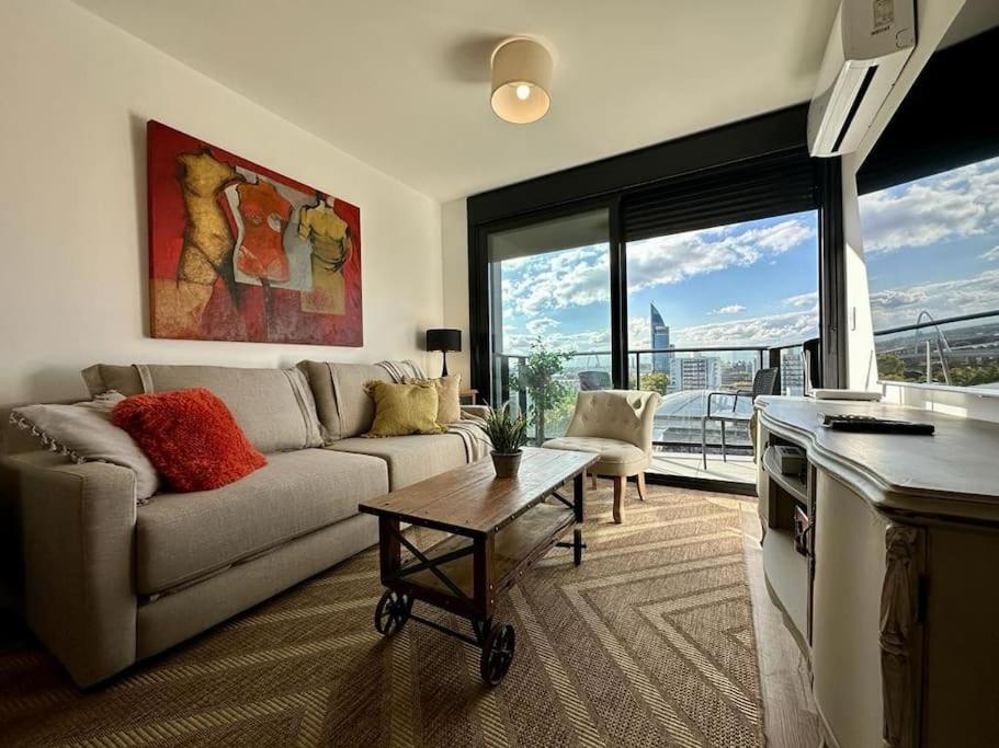 a living room with a couch and a table at Brand New apartment near port - piso 11 in Montevideo