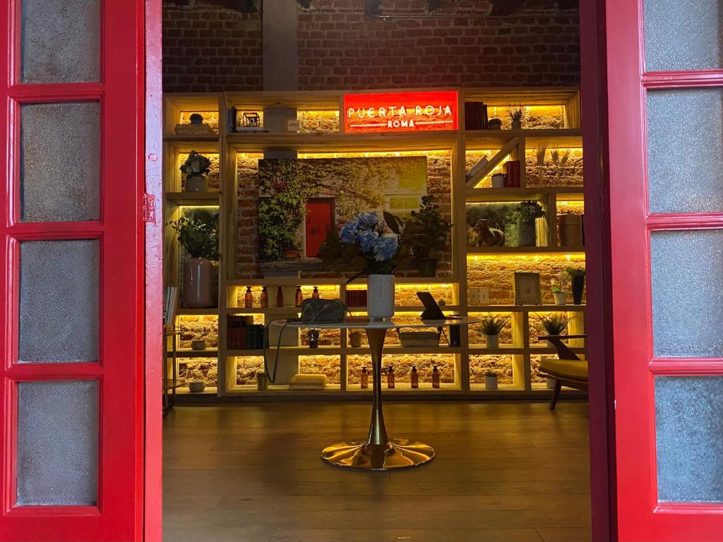 a store front with a red door and a window at Casa en corazón de la colonia roma Jacuzzi in Mexico City