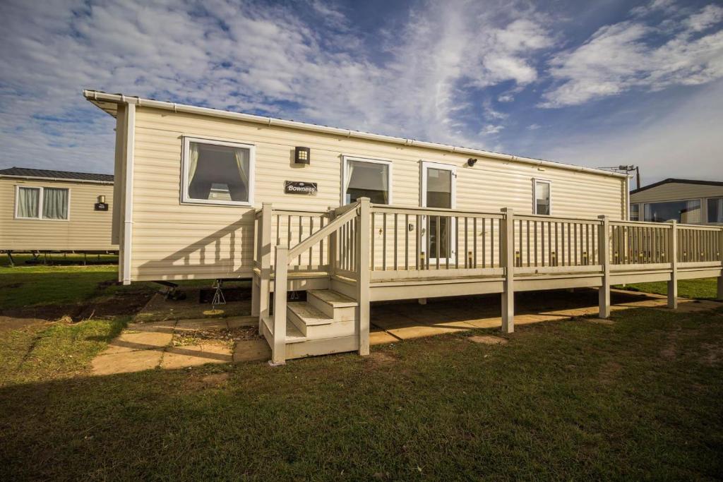 a mobile home with a porch and a deck at Lovely 6 Berth Caravan Nearby Hunstanton Beach In Norfolk Ref 23071t in Hunstanton