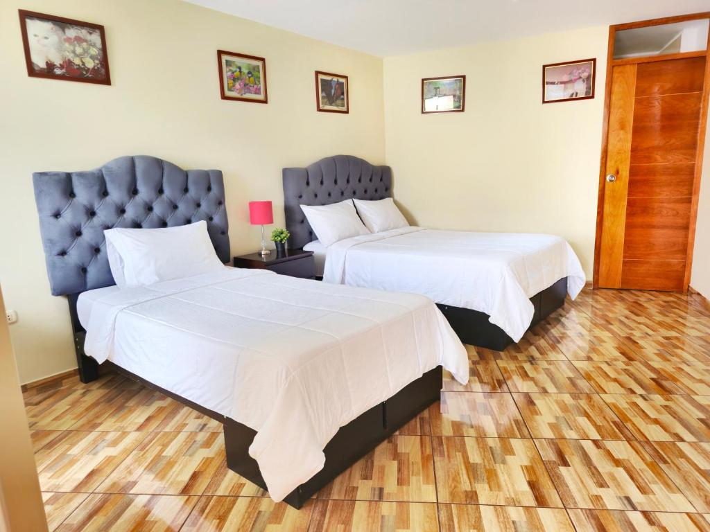Postel nebo postele na pokoji v ubytování Hospedaje Celerina & Elio