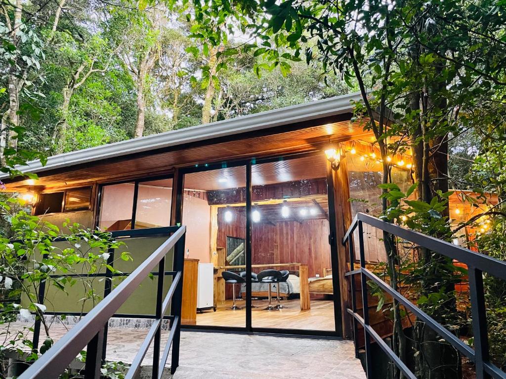a tiny house in the woods with a table at Cabañas La Montaña Mountain Lodge in Monteverde Costa Rica