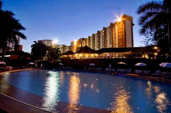 a large swimming pool in front of a large building at Hot springs - suíte Premium in Caldas Novas