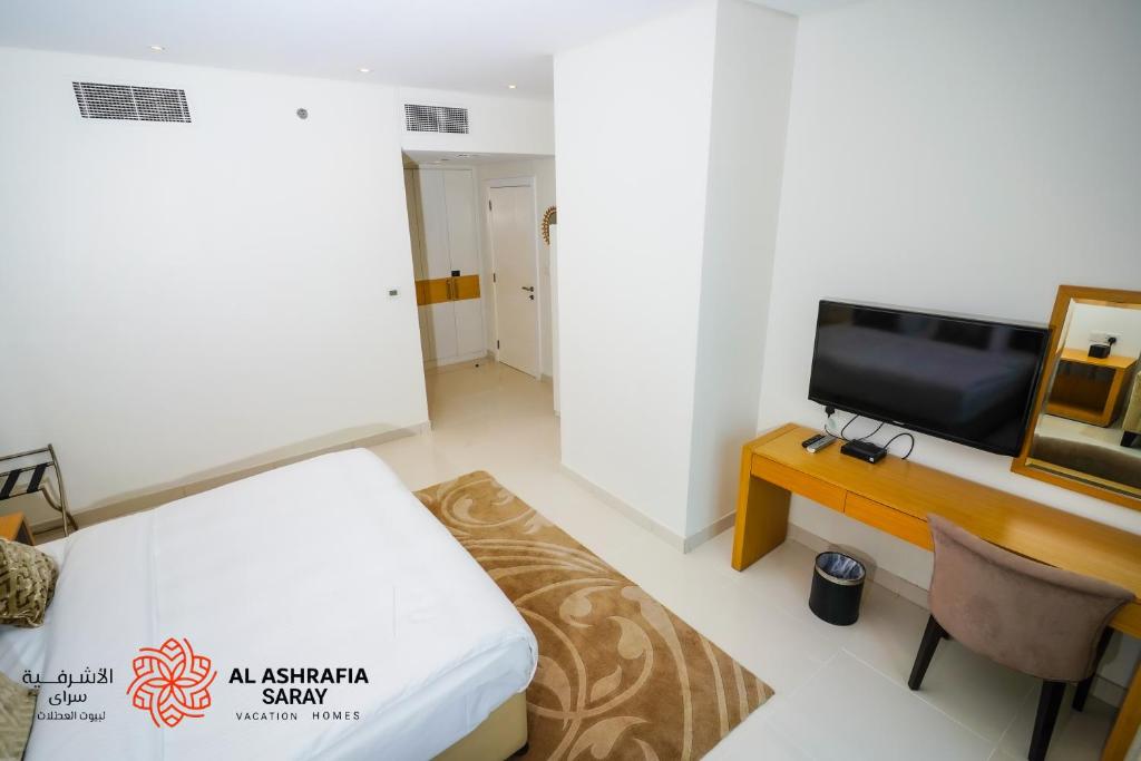 TV a/nebo společenská místnost v ubytování Alashrafia Saray - Fabulous 1BR in Canal Views