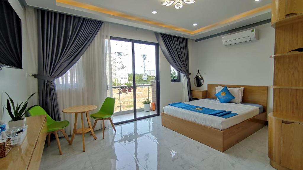 a bedroom with a bed and a table and chairs at Phuong Linh Mini Hotel in Phan Rang