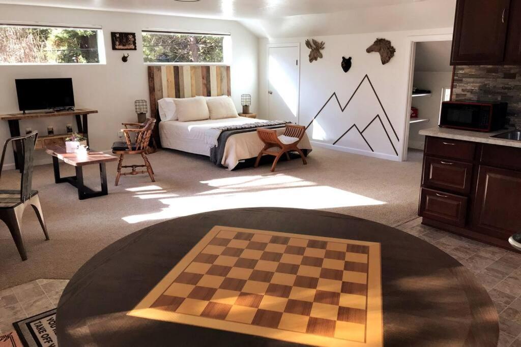 a bedroom with a chess board in the middle of a room at Spacious upstairs studio with kitchenette & 1 bath in Grants Pass