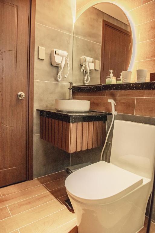 a bathroom with a white toilet and a sink at Villa Hoa Da in Da Lat