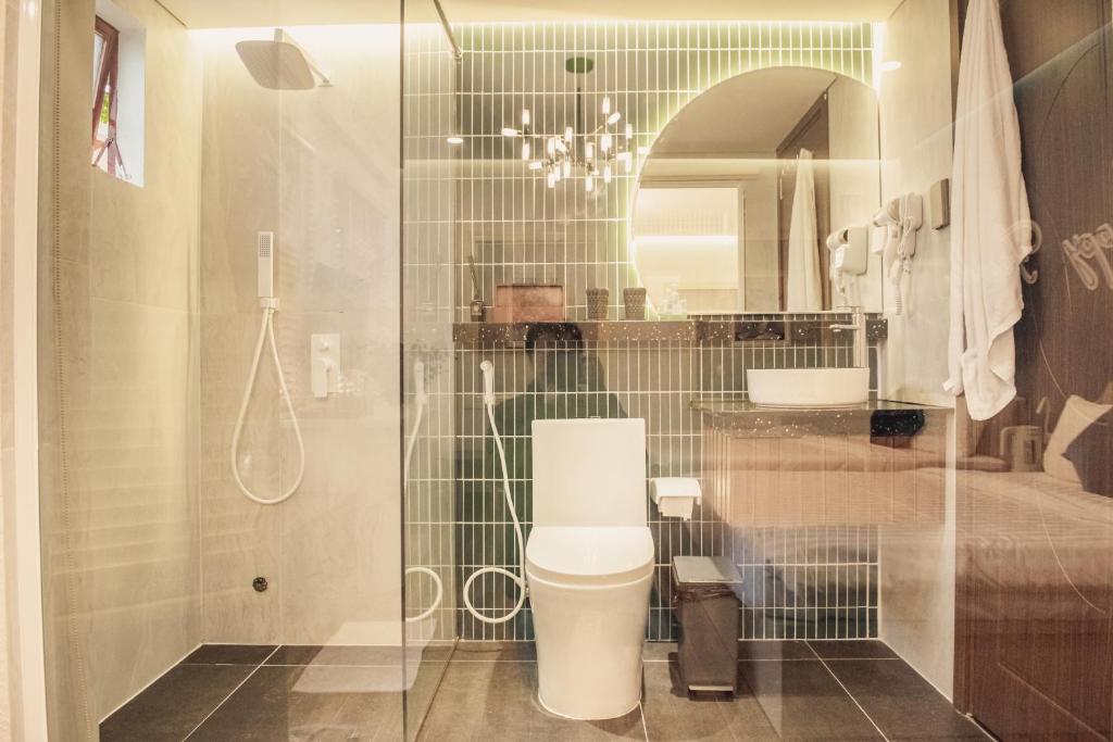 a bathroom with a shower with a toilet and a sink at Villa Hoa Da in Da Lat