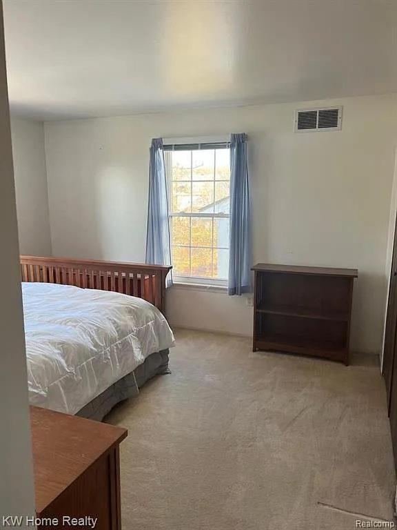 a bedroom with a bed and a dresser and a window at Budget 3 bedrooms homestay in Northville