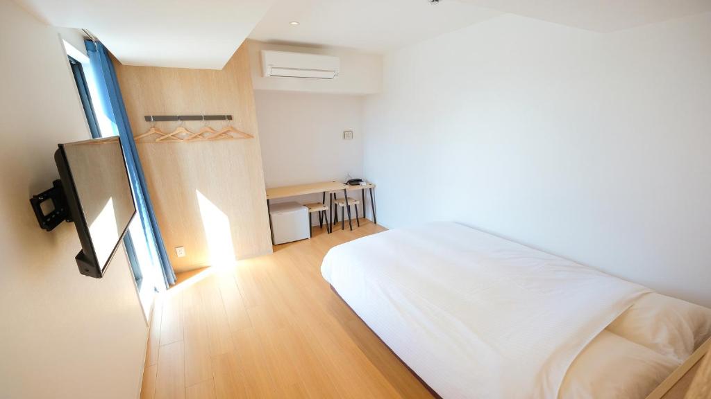 Postel nebo postele na pokoji v ubytování ELE Hotel Kuzuha