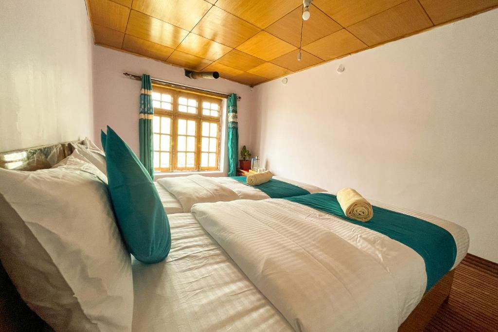 a large bed in a room with a window at Astrostays at Pangong in Spangmik