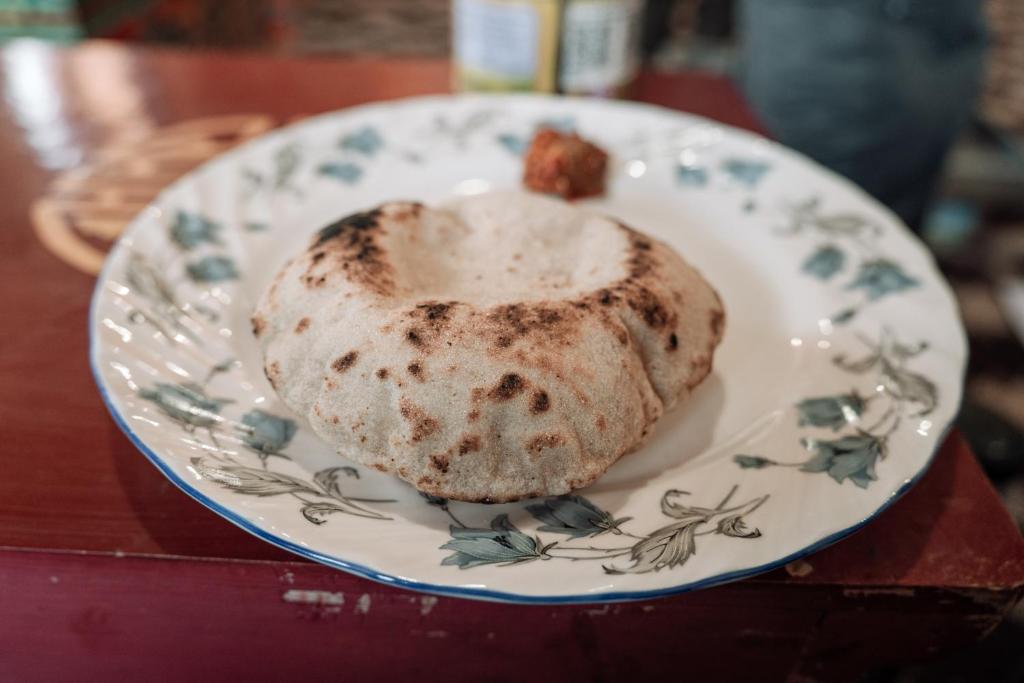 a doughnut on a plate on a table at Astrostays at Pangong in Spangmik