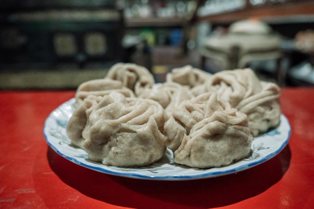 a plate of dumplings on a red table at Astrostays at Pangong in Spangmik