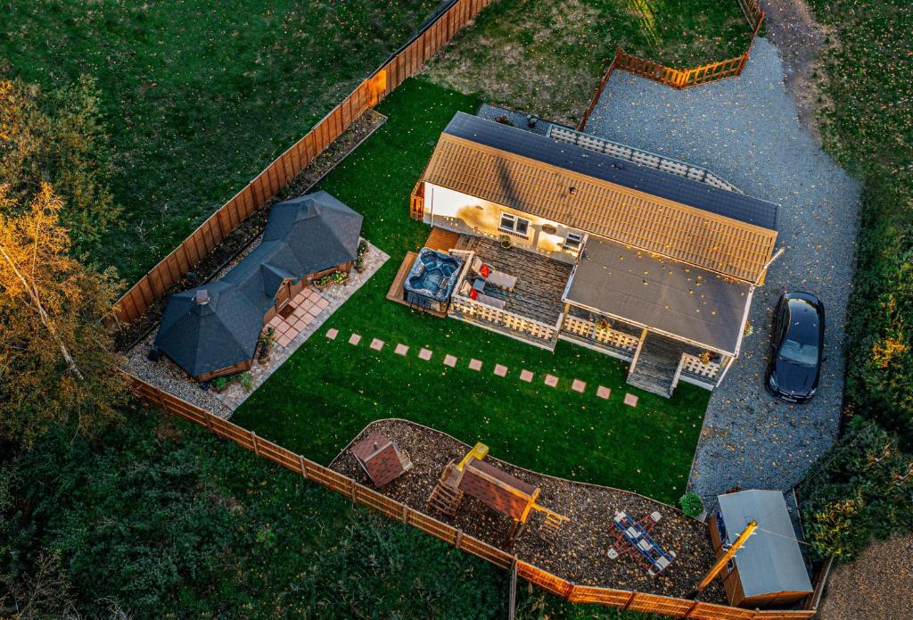 an overhead view of a house with a yard at Bespoke Holiday Home With Private Pool And Hot Tub, Sleeps 8 Ref 34073p in Kings Lynn