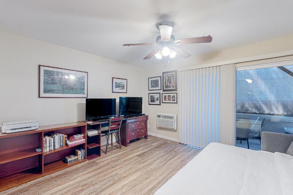 a bedroom with a bed and a flat screen tv at The Heart of Mission Valley in San Diego