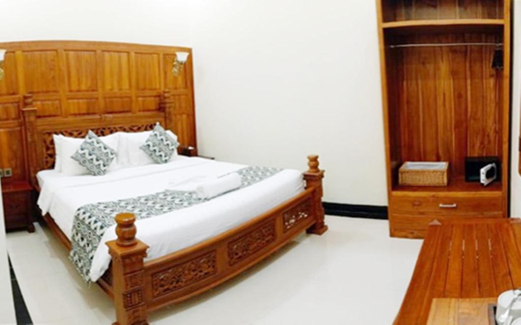 Postel nebo postele na pokoji v ubytování Tirtodipuran Hotel by Natts Hospitality Indonesia