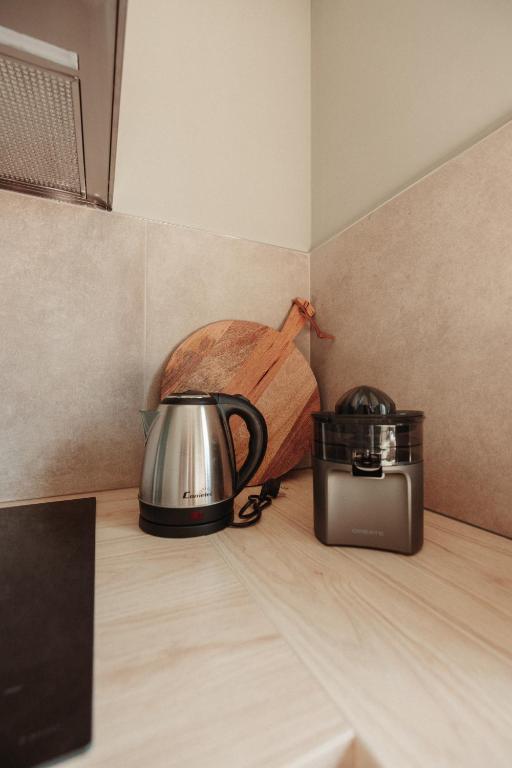 a tea kettle and a toaster on a kitchen counter at Casa Velha Apartments - Adults friendly in Albufeira