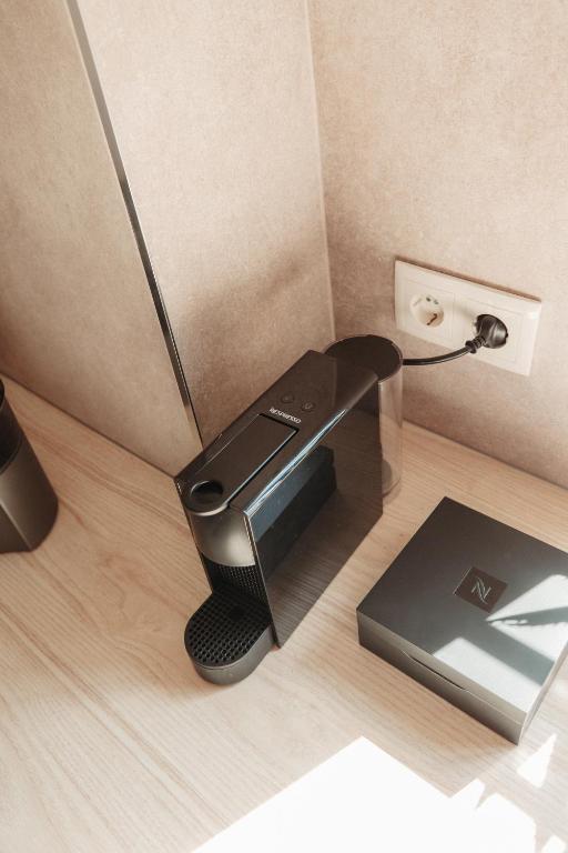 a coffee machine sitting on the floor in a room at Casa Velha Apartments - Adults friendly in Albufeira
