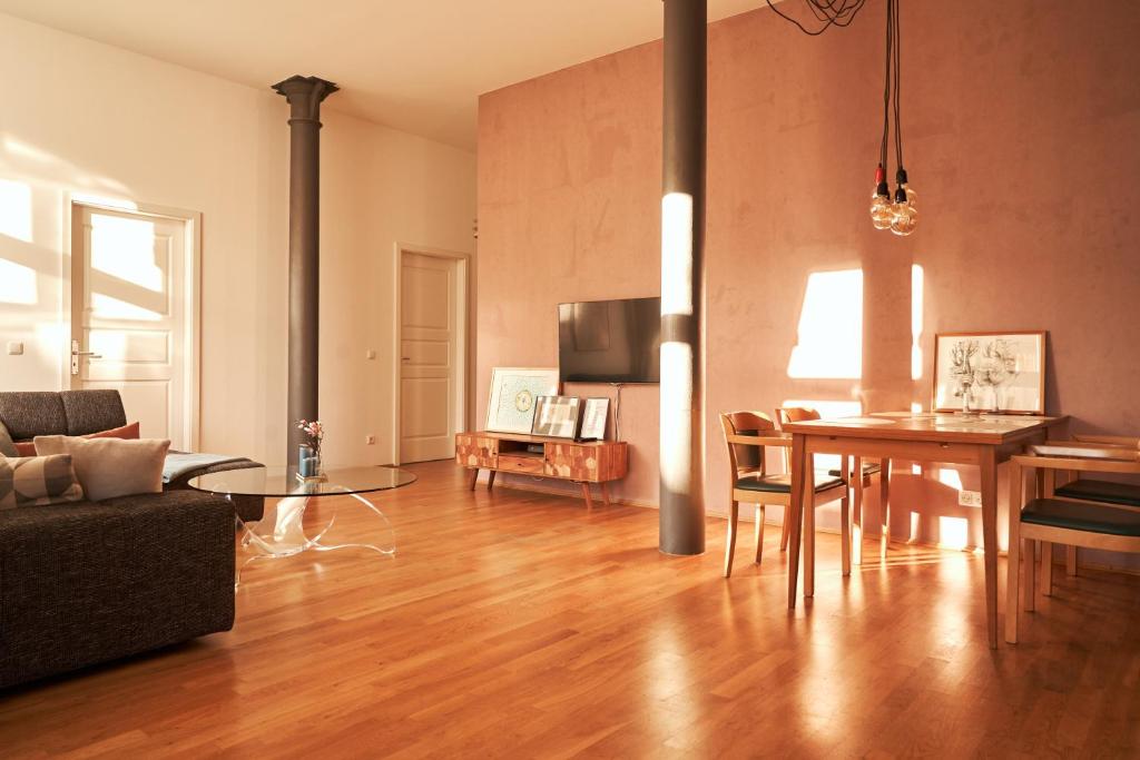 ein Wohnzimmer mit einem Tisch und einem Esszimmer in der Unterkunft Cityloft - im Zentrum, inkl Parkplatz, Netflix, 3-Raum in Leipzig