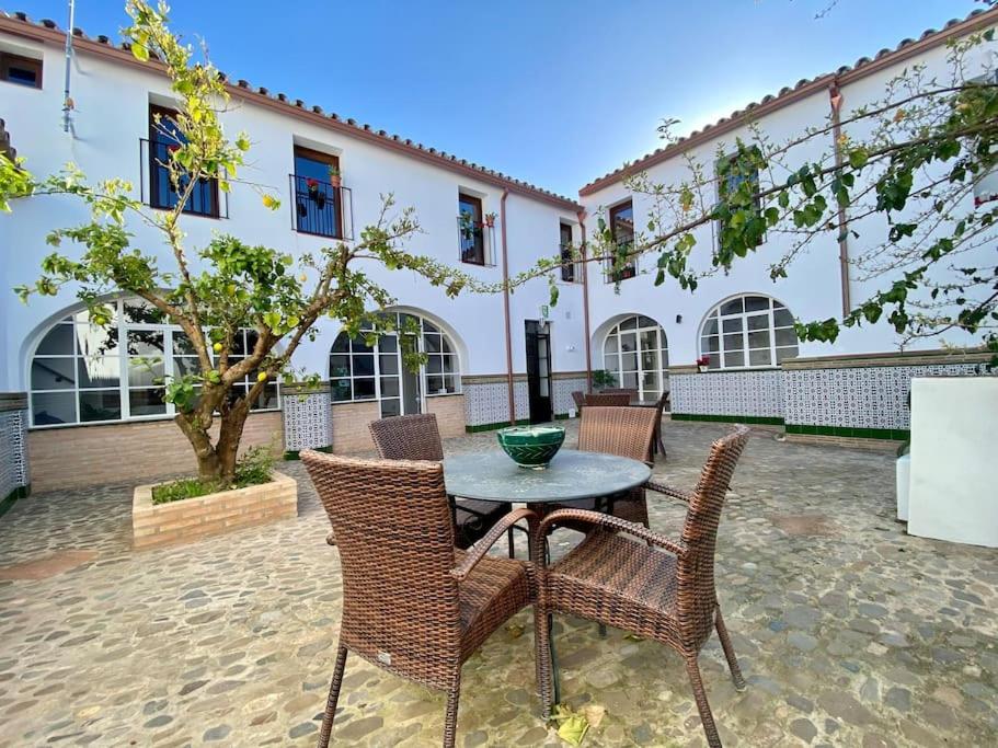 a patio with a table and chairs in front of a building at Casa del Marqués in Fregenal de la Sierra