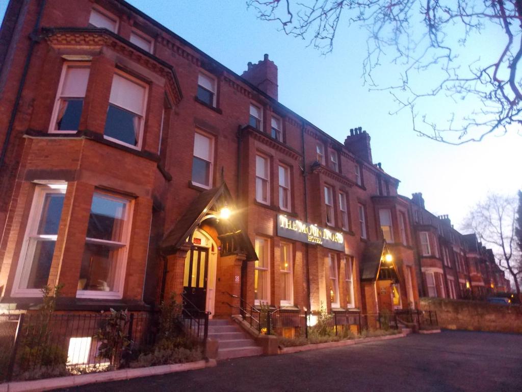 a large red brick building on a street at The Mountford Hotel in Liverpool