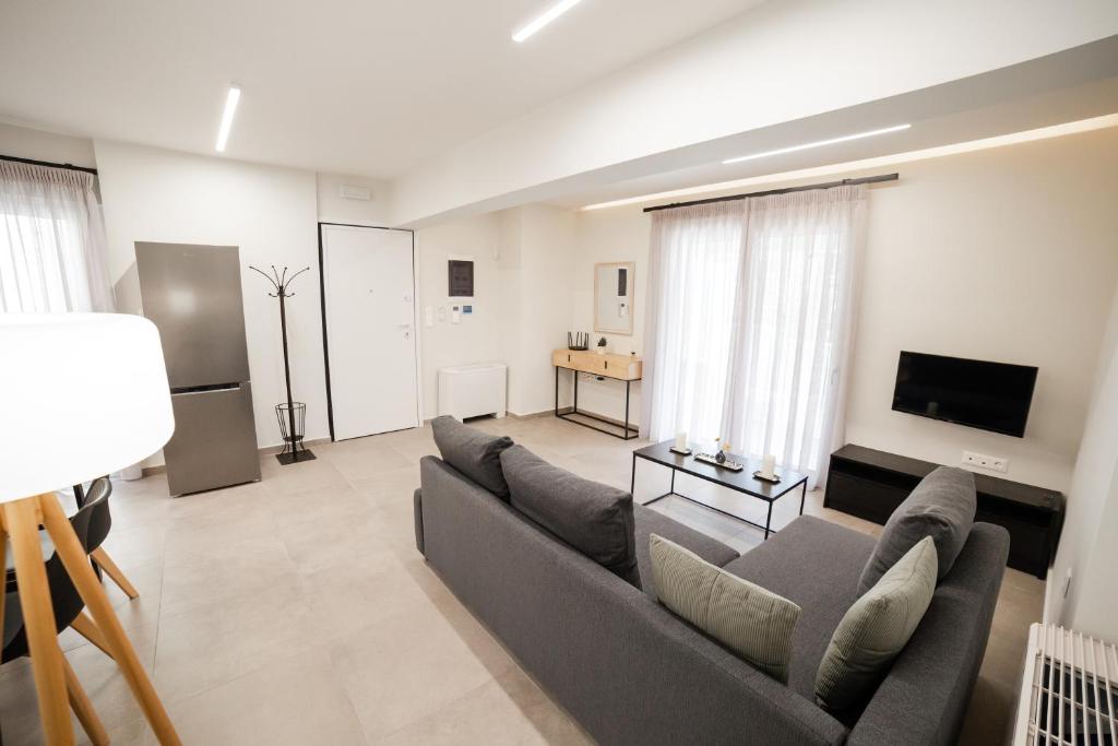 a living room with a couch and a tv at Athens Heart Luxury Flat in Athens