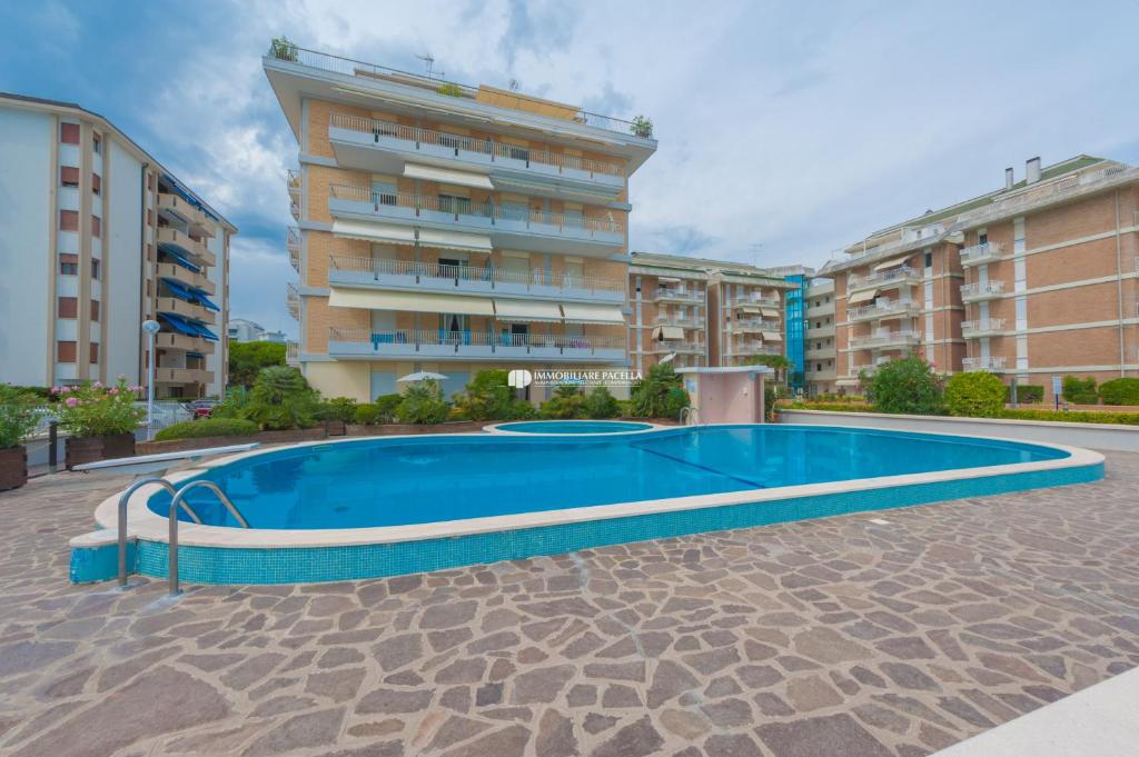 a large swimming pool in front of a building at Residence Solmare Immobiliare Pacella in Lido di Jesolo