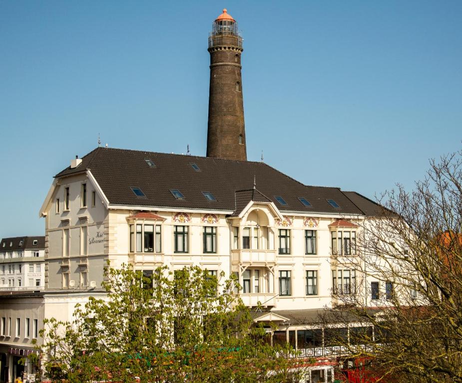 a building with a lighthouse on top of it at Hotel Rummeni in Borkum