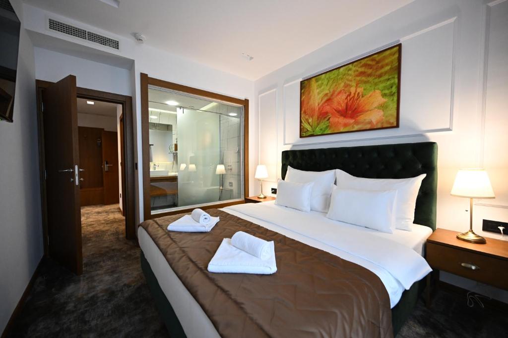 Postel nebo postele na pokoji v ubytování Hotel Tamiš & Spa