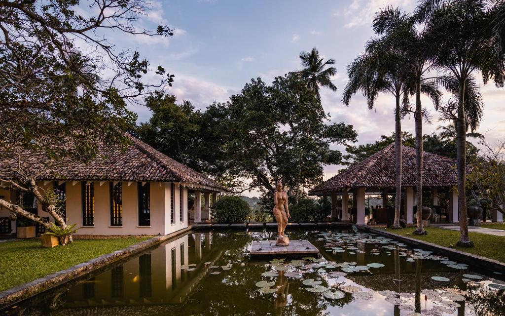 a pond in front of a house with lilies at Kahanda Kanda in Koggala