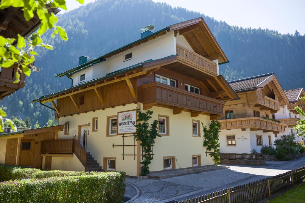 a large building with a mountain in the background at Mountainpeak in Mayrhofen
