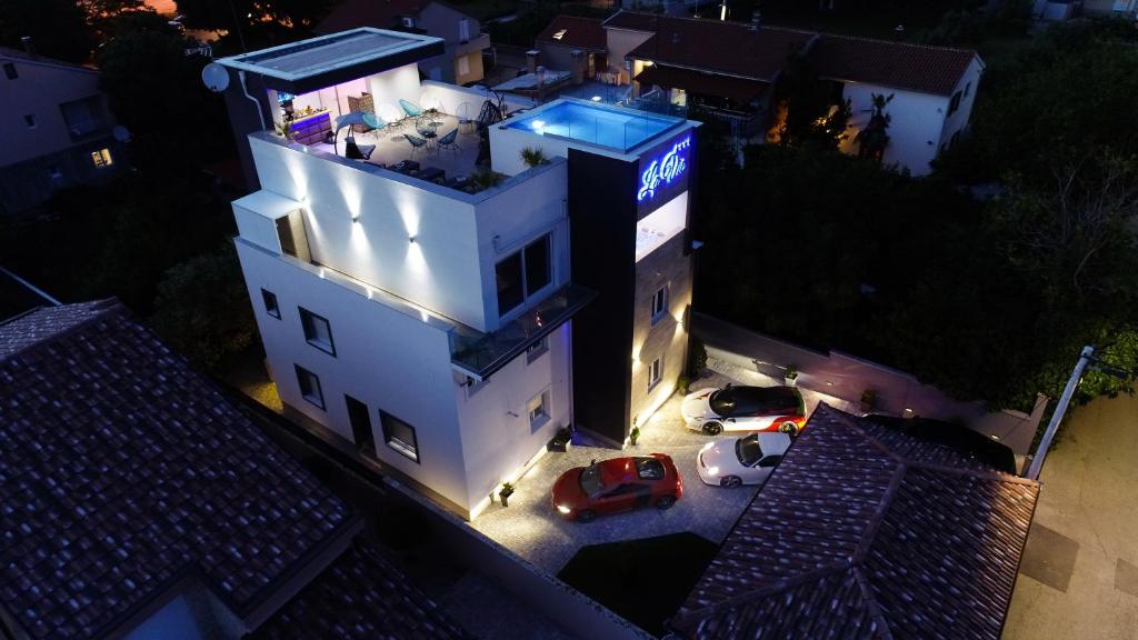 a white building with a car parked in front of it at Luxury Rooms LaVie - Standard Rooms in Zadar