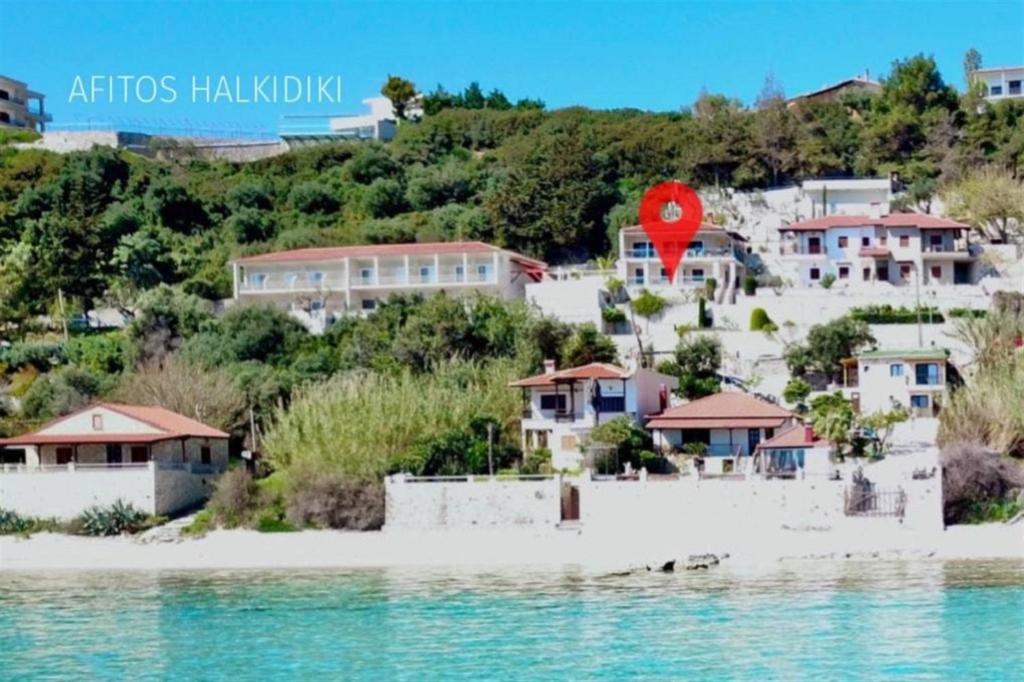 a view of a beach with houses and the water at Irini Traditional House Afitos in Afitos