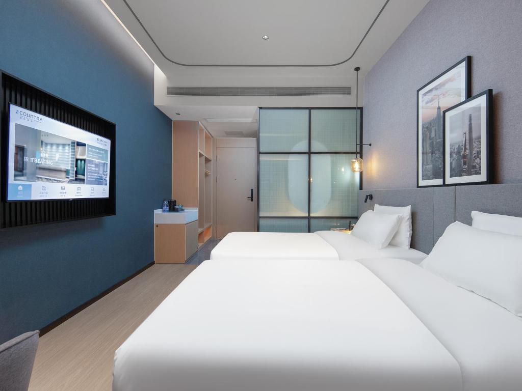 Postel nebo postele na pokoji v ubytování Country Inn & Suites by Radisson - Taishan East Branch