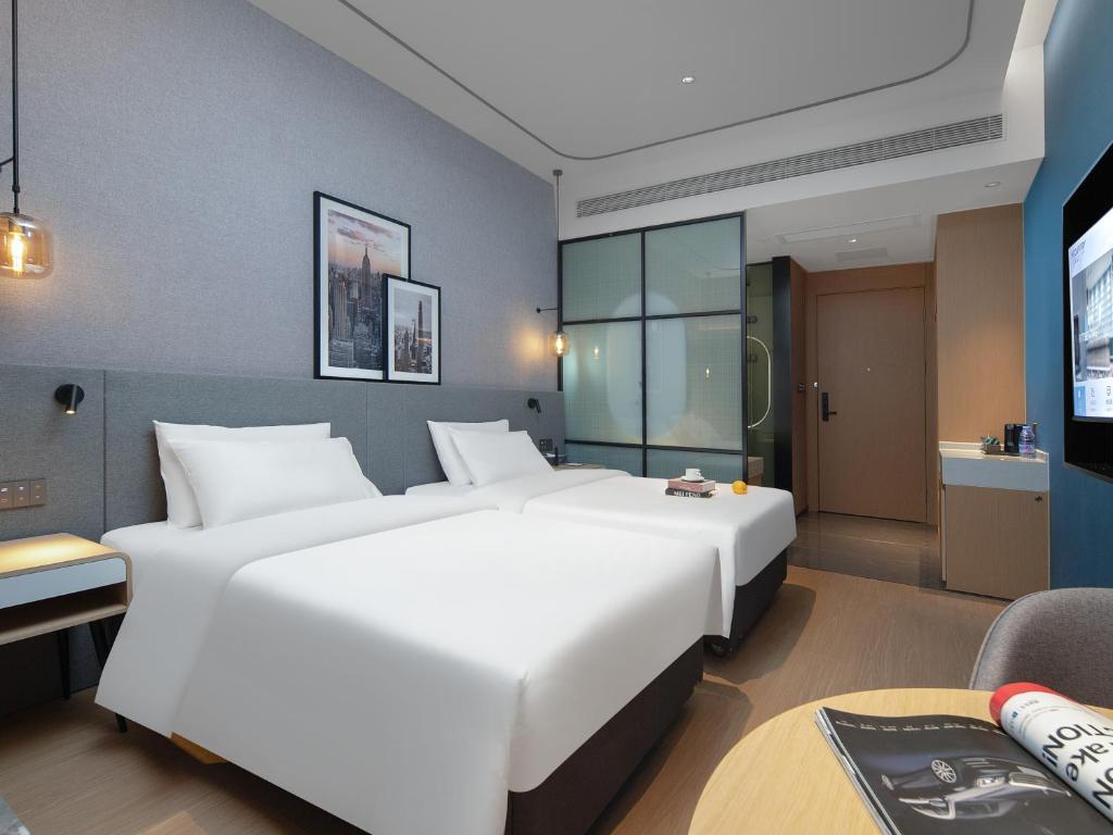 Postel nebo postele na pokoji v ubytování Country Inn & Suites by Radisson - Taishan East Branch