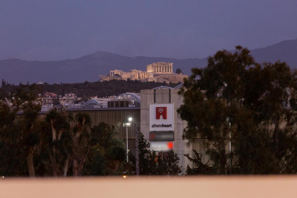 a building with a sign in front of a city at Athens Heart Luxury Penthouse in Athens