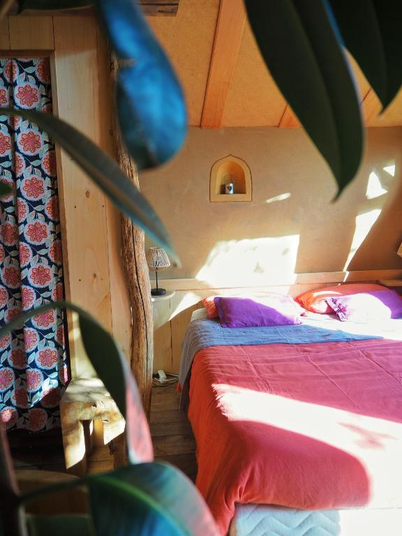 Postel nebo postele na pokoji v ubytování Ecolodge La Belle Verte