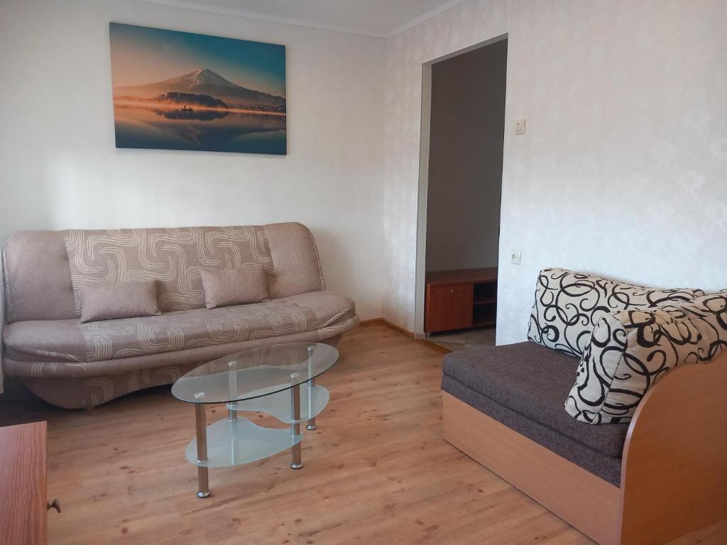 a living room with a couch and a glass table at Sunny Ventspils 21 in Ventspils