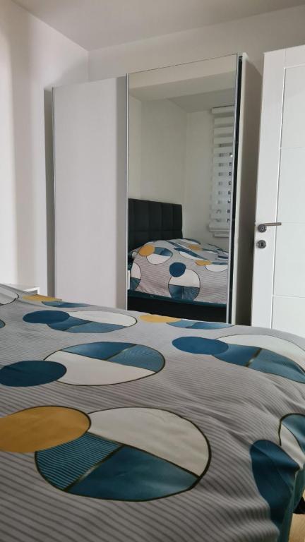 a bedroom with a bed and a mirror at Apartman 222 in Brčko