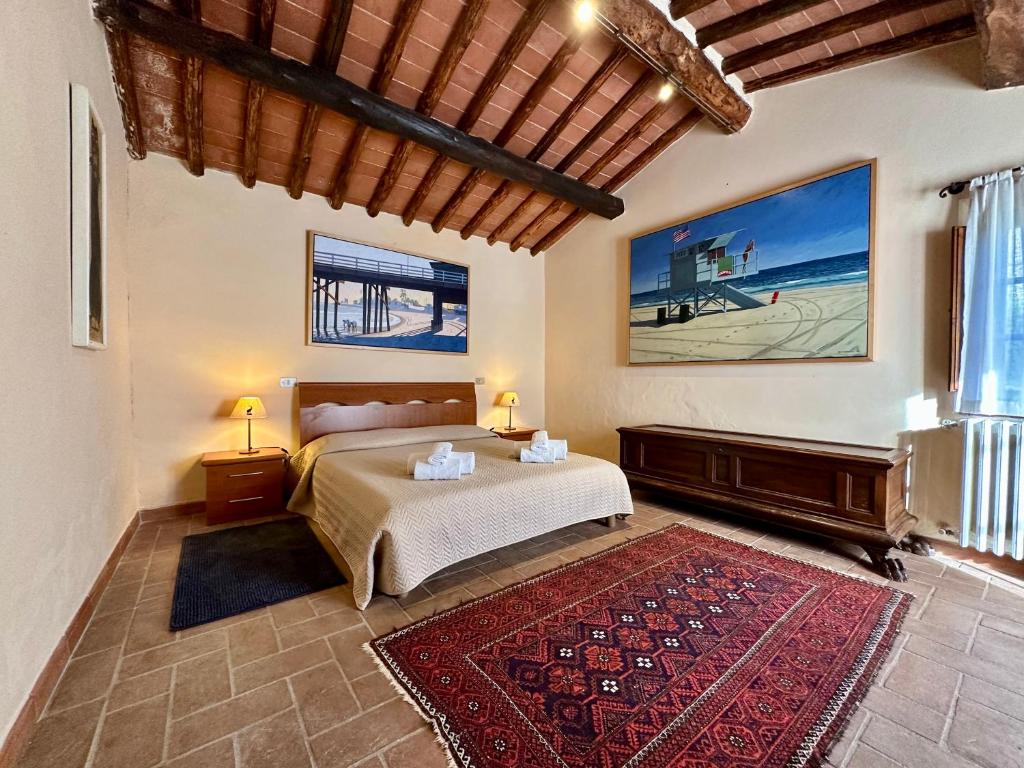 a bedroom with a bed and a red rug at Agriturismo Vinci in Gaiole in Chianti