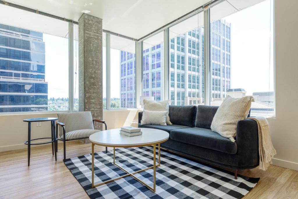 a living room with a couch and a table at Downtown Bellevue 2BR w Lounge Gyms nr shops SEA-122 in Bellevue