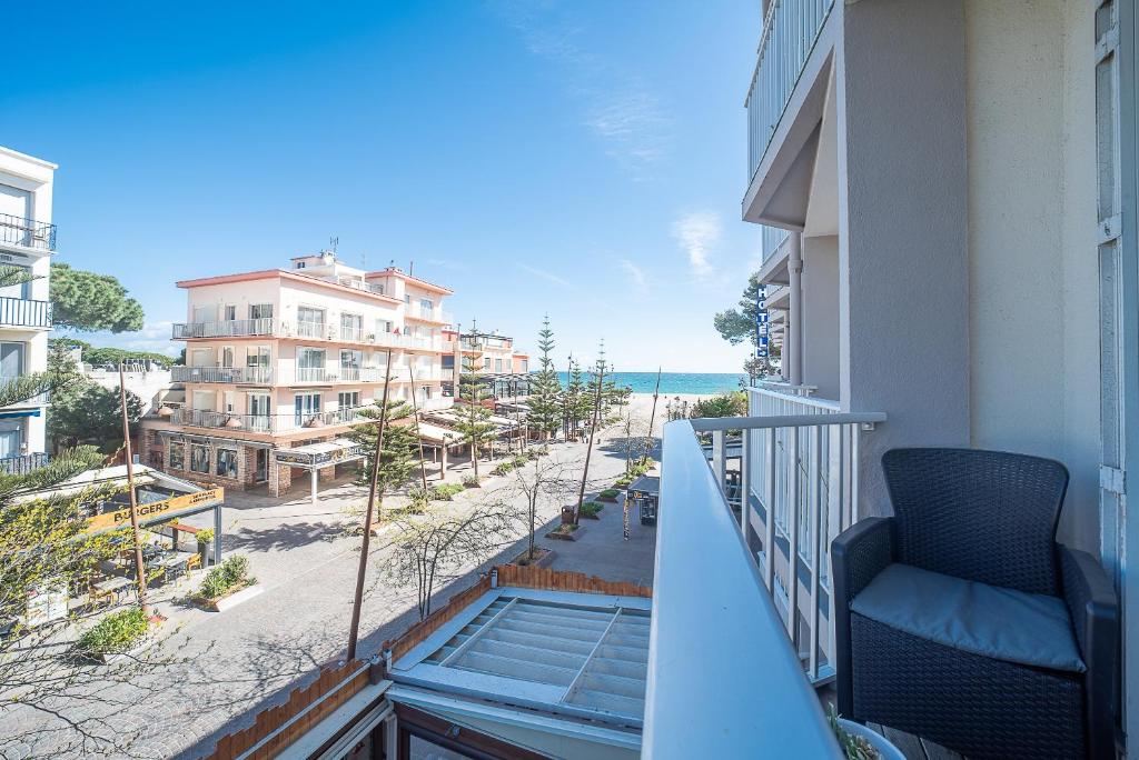 d'un balcon avec une chaise et une vue sur la plage. dans l'établissement Les Arcades - Appartement vue mer, à Argelès-sur-Mer