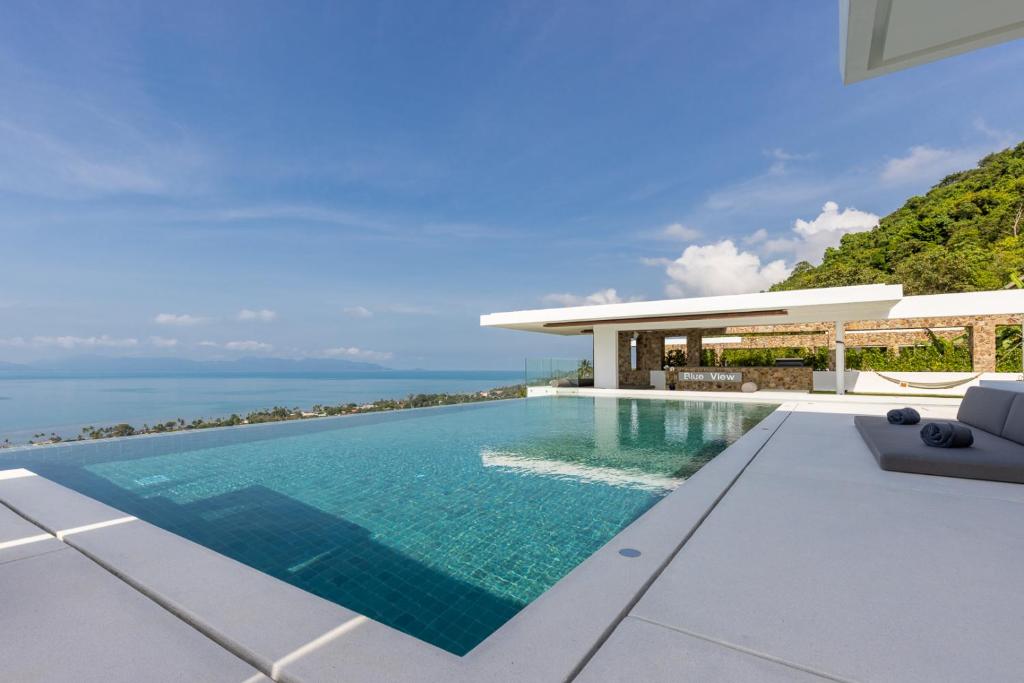 an infinity pool in front of a villa at Villa Blue View Luxe in Mae Nam