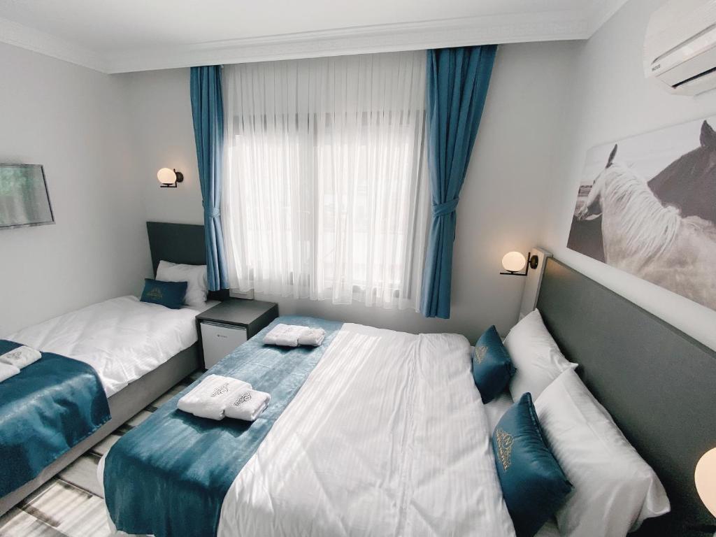 Postel nebo postele na pokoji v ubytování Nefis Hotel City