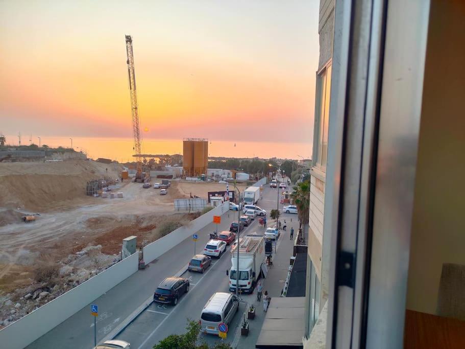 a view from a window of a street with cars at Havakouk Beach apartment in Tel Aviv