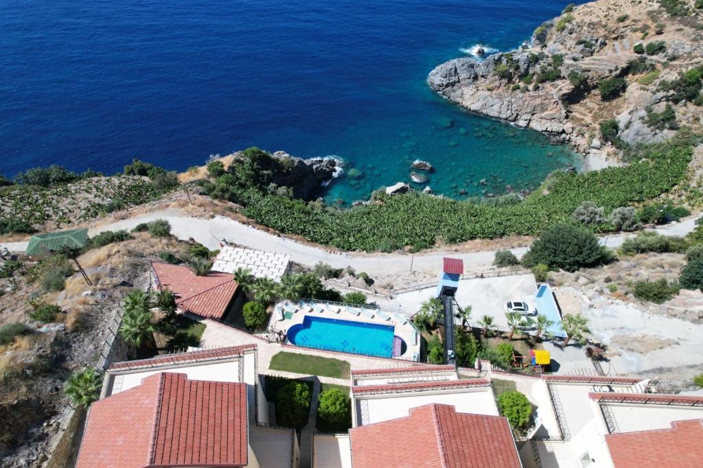 an aerial view of a house and the ocean at Blue Lagoon Village in Gazipasa