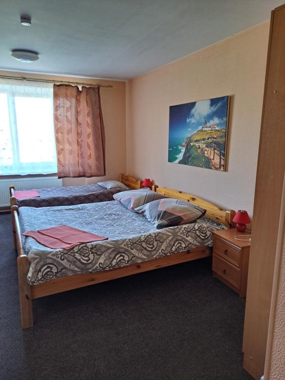 a bedroom with two twin beds and a dresser at The Bunker hostel in Liepāja