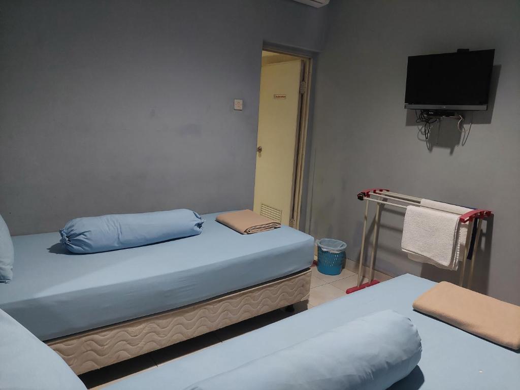 Postel nebo postele na pokoji v ubytování Pondok Seruni Kemanggisan Jakarta