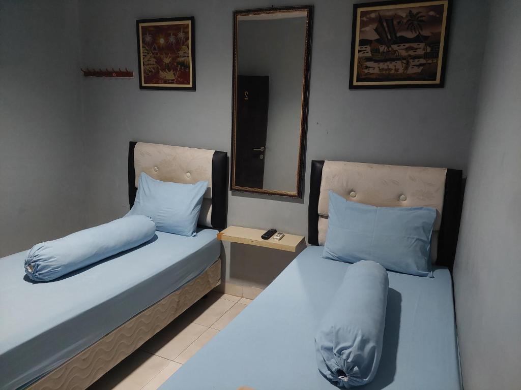 Postel nebo postele na pokoji v ubytování Pondok Seruni Kemanggisan Jakarta