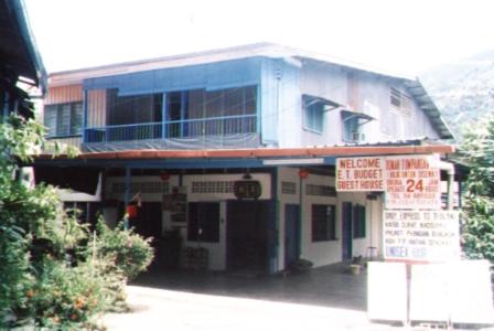 a building with a sign in front of it at ET Budget Guest House in Batu Ferringhi