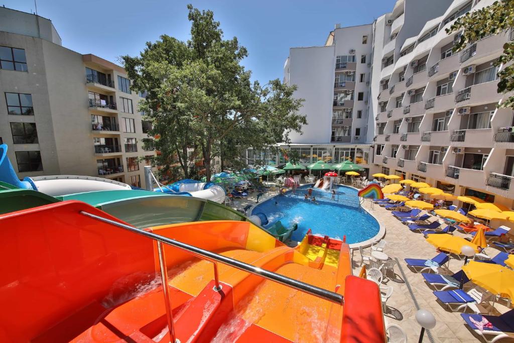 a pool in a hotel with chairs and umbrellas at Prestige Deluxe Hotel Aquapark Club - All inclusive in Golden Sands